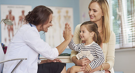 Doctor highfiving a child